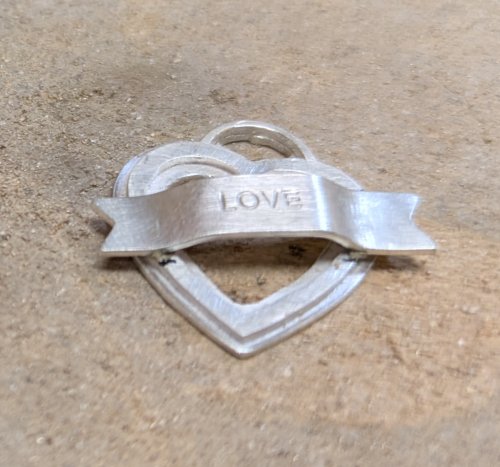 Judy Larson's Hearts and Flowers Charms - , Classic Wire Jewelry, Cutting, Cutting Tool, Cutters, Filing, Finishing, Butane Torch, Soldering, Solder, Design, Push embellishment into place on the heart.